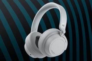 white heaphones on black green backgroud, with a Windows logo on side of headband